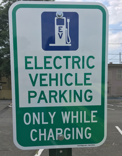 Sign for Electric Vehicle Parking - only while charging - in Hudson, NY